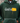 Green hoodie with 'God is' text and yellow design on a blurred background